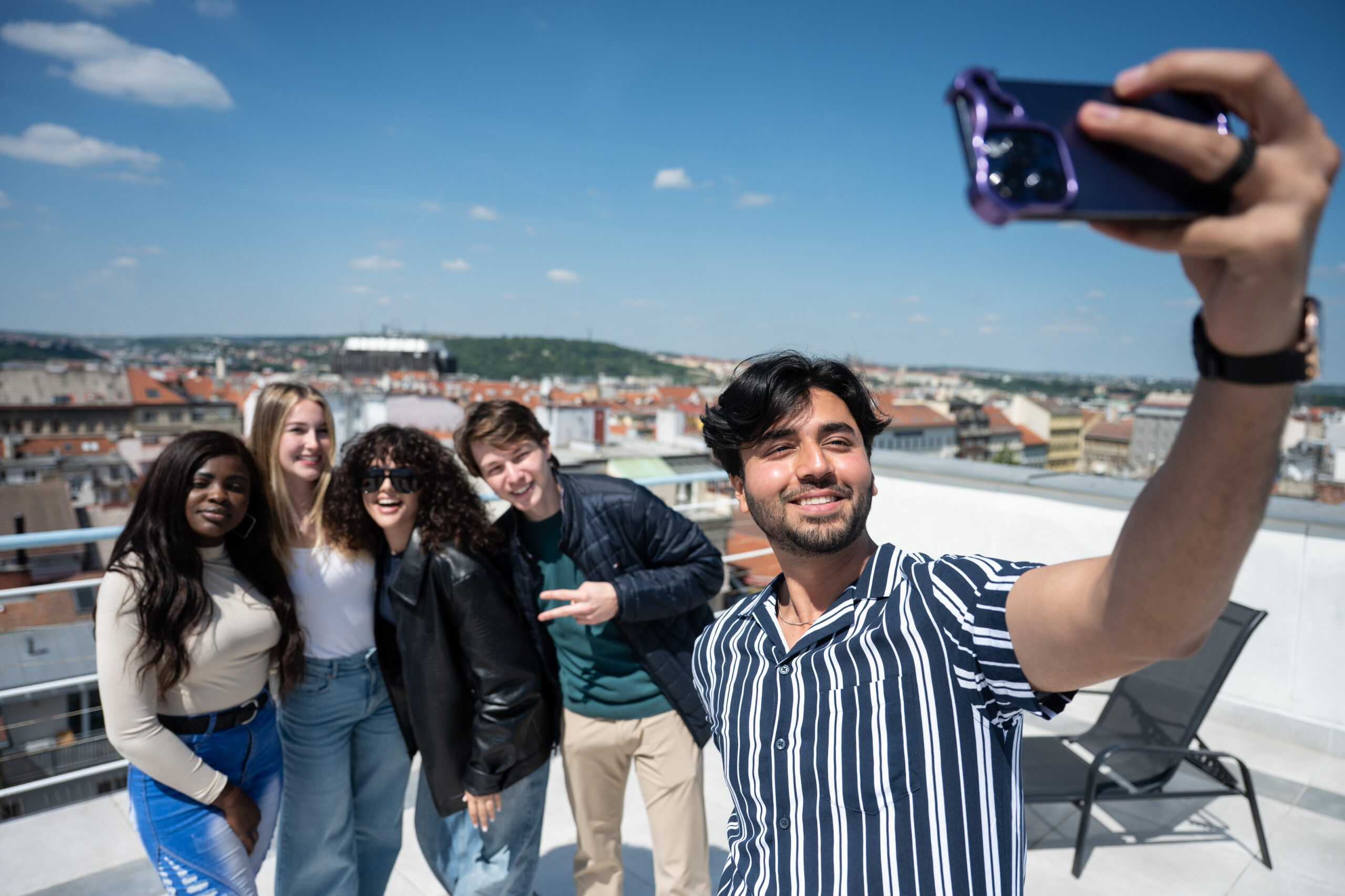 UNYP university students pose for a group selfie on the roof of the main campus building during orientation week